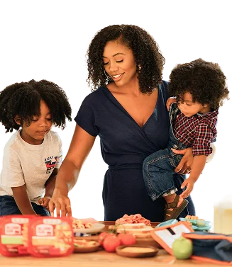 Mother preparing a healthy meal with her two children, choosing fresh ingredients together